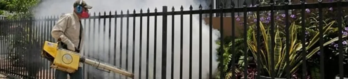 Mosquito control technician fogging a yard perimeter for mosquito reduction in Scottsdale, AZ